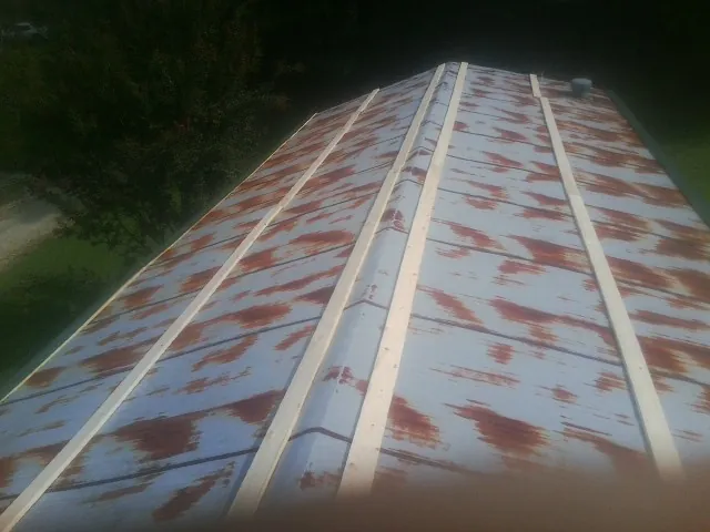 Rusted metal roof panels with new wood purlins before replacement — Storm Damage Roof Repair in Divernon by Roofing Brothers