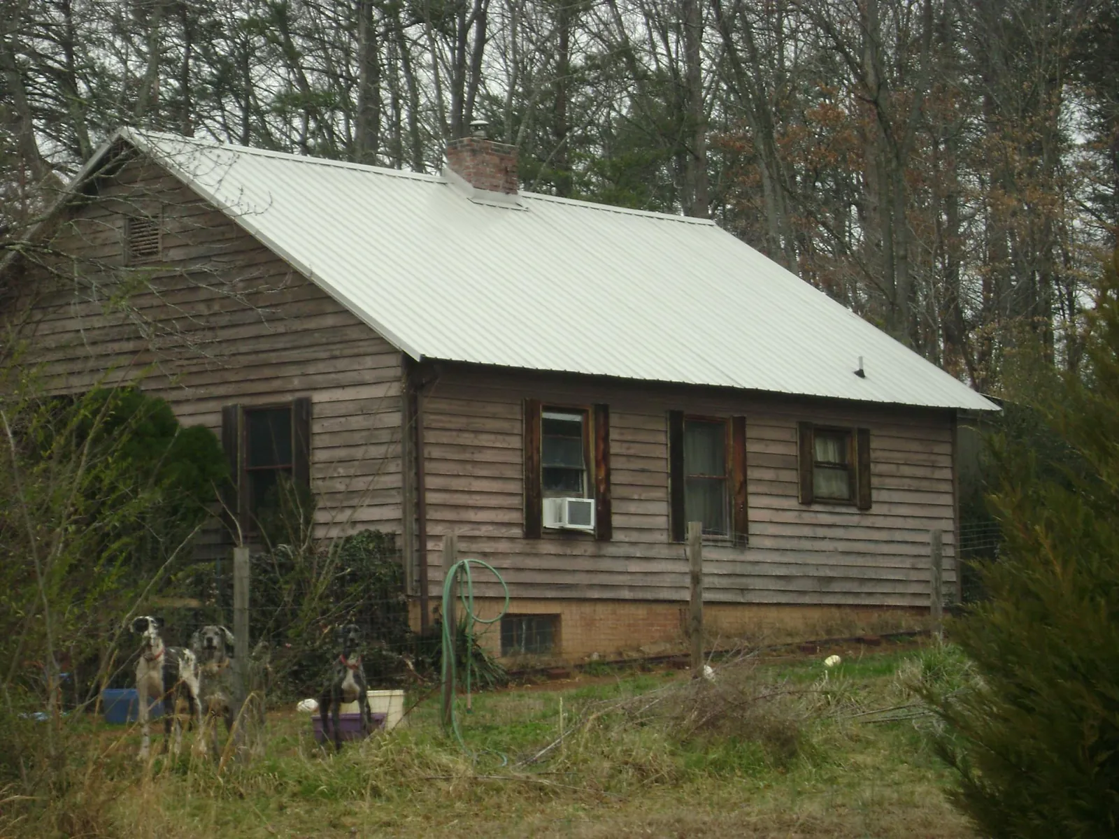 White metal roof on an old wood sided farmhouse, from a Metal Roof Installation job in Divernon